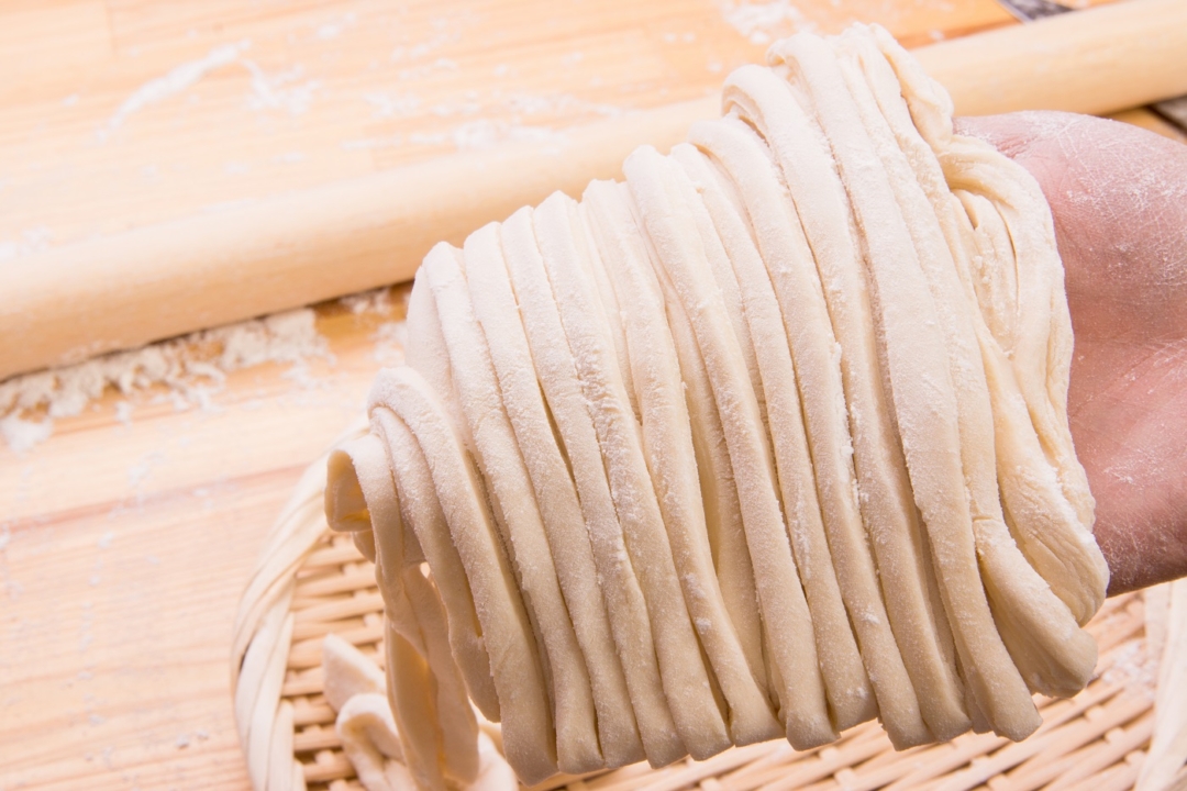 Raw udon noodles before boiling.